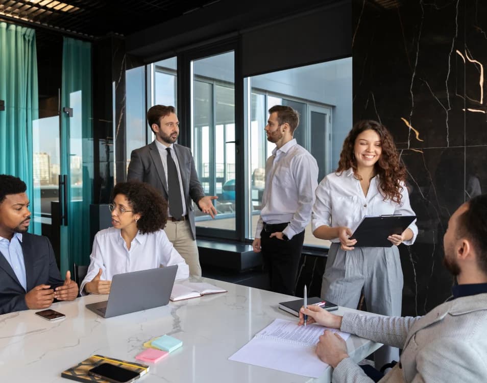 Team gathered around a table discussing a project in an office